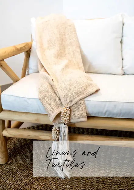 Woven rattan lounge chair with a throw